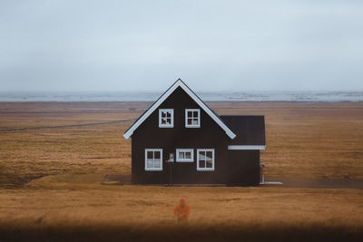 House on beach against sky