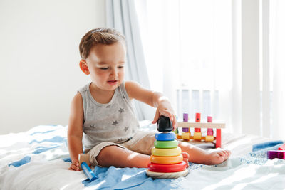 Cute boy playing with toy at home