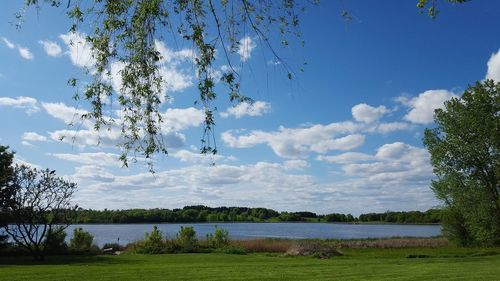Scenic view of lake against cloudy sky