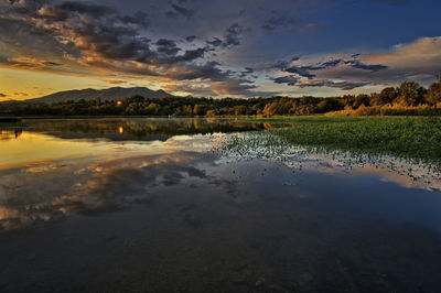 Scenic view of lake against sky during sunset