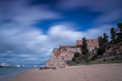 Historic building by sea against sky