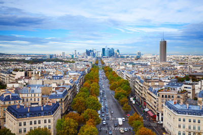 High angle view of city street against cloudy sky