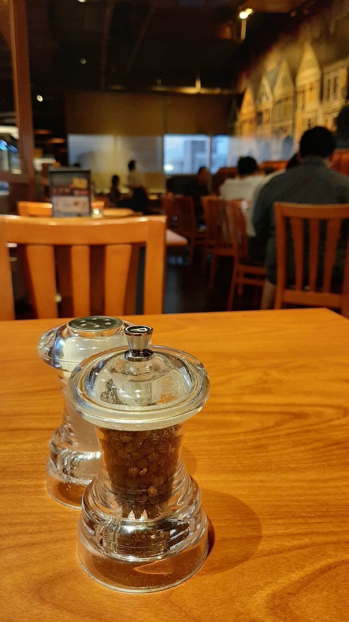 CLOSE-UP OF BEER GLASS ON TABLE