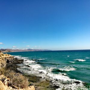 Scenic view of sea against clear blue sky