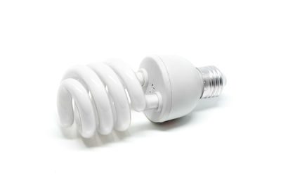 Close-up of light bulb against white background