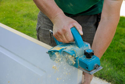 Midsection of man working in yard