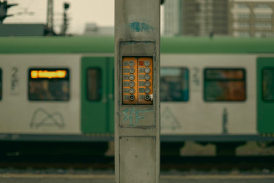 Control panel at train station with blurred train in background 