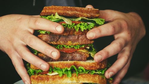 Close-up of hand holding burger