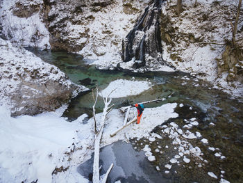 High angle view of man on rock during winter
