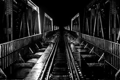 Railroad tracks in bridge at night