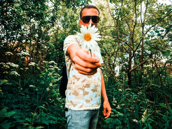 Midsection of man holding flower