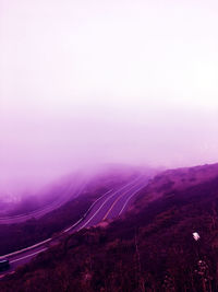 Scenic view of landscape against sky during foggy weather