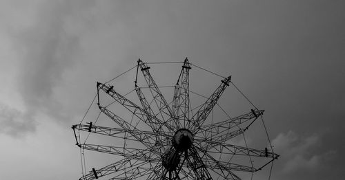 Low angle view of silhouette ferris wheel against sky