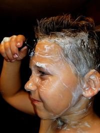 Close-up of boy with soap sud in bathroom