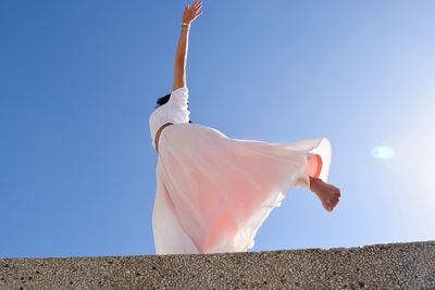 Low angle view of a dancing woman