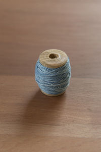 High angle view of spool on wooden table