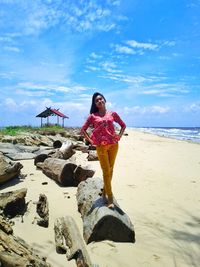 Full length of young woman on beach
