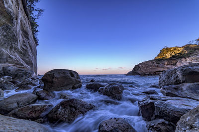 Scenic view of sea against clear blue sky