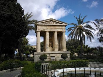 Low angle view of building against cloudy sky