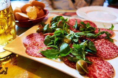 Close-up of appetizer served on table with beer