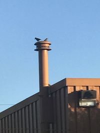 Low angle view of smoke stack against sky