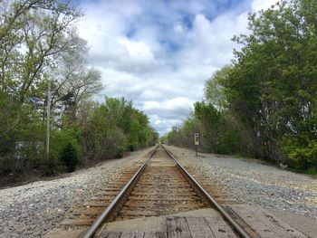 Railroad track against cloudy sky