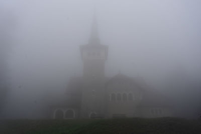 Buildings against sky in foggy weather