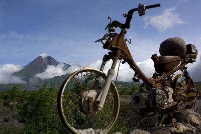 Bicycle on field against sky