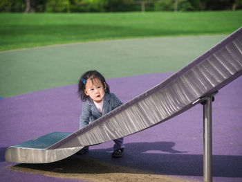 Portrait of girl by slide at park