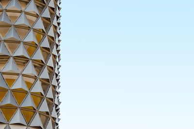 Low angle view of modern building against blue sky