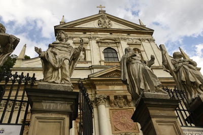 Low angle view of statue against historic building