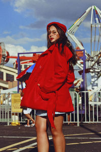 Portrait of young woman standing at amusement park