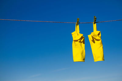 Low angle view of clothes hanging against clear sky