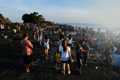 People on beach against sky