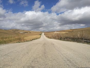 Empty road along countryside landscape