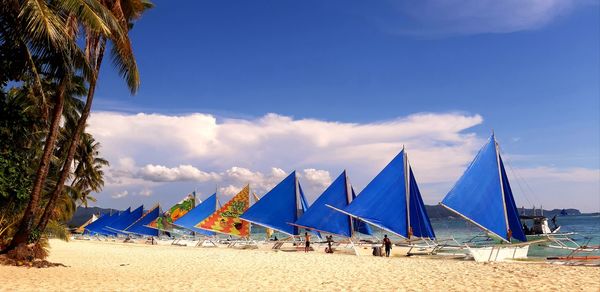 Scenic view of beach against blue sky