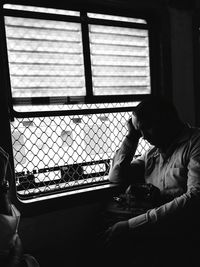 Man sitting on window