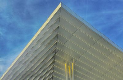 Low angle view of modern building against blue sky