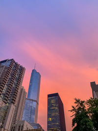 Low angle view of buildings against sky during sunset