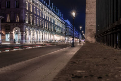 Illuminated light trails on road in city at night