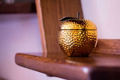 Close-up of golden artificial apple on table