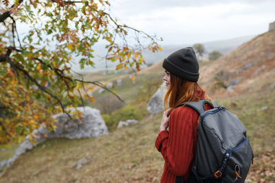 Rear view of woman standing against mountain