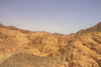 Scenic view of arid landscape against clear sky