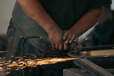 Midsection of man working on table