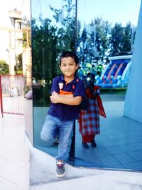 Portrait of smiling girl standing in city