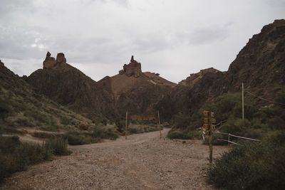 Road leading towards mountains against sky