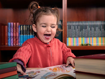 Portrait of happy girl with book