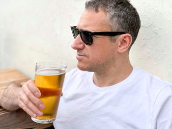 Middle aged man is drinking beer in cafe or restaurant pub outdoor. drinking alcohol lager or ale