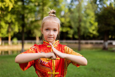 Portrait of young woman holding umbrella