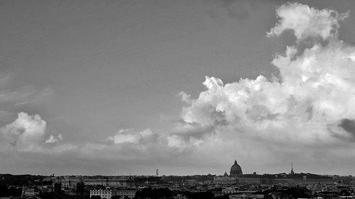 Buildings against cloudy sky